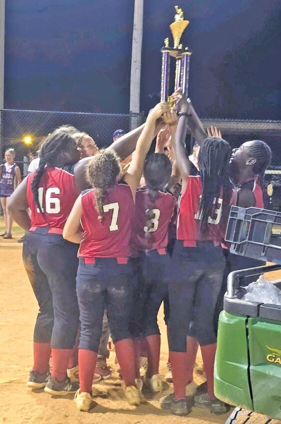 The Barnwell Ponytails All-Stars hold their state championship trophy high in the air after the win.
