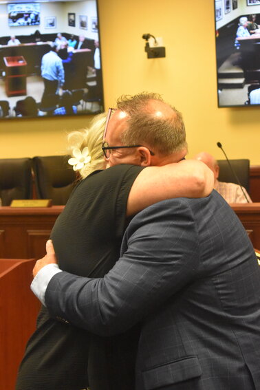 Jodi Croft, the daughter of the late Eugene "Buddy" Darnell, hugs Mayor Ron Still at the City's July 1 meeting where Mr. Darnell's legacy was honored. 