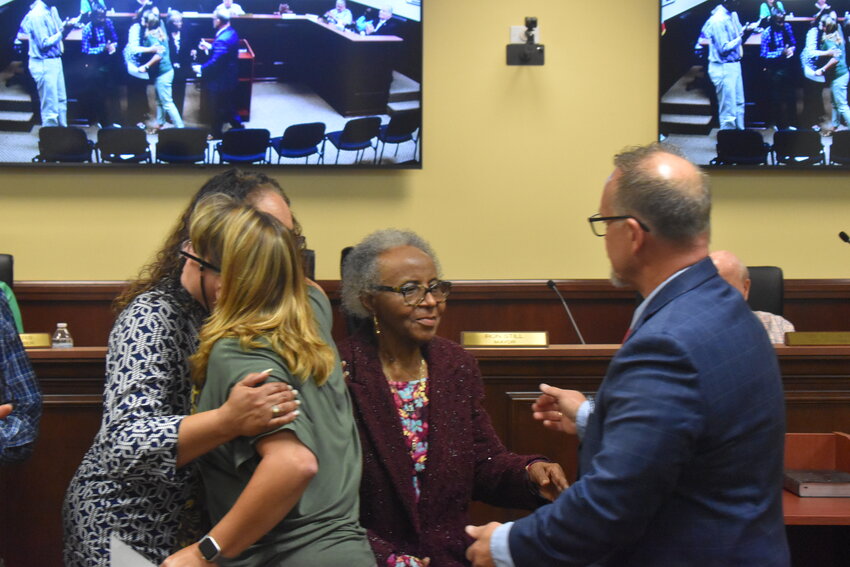 Belinda Guinyard, the daughter of the late William F. Guinyard, hugs City of Barnwell administrator Lynn McEwen after a resolution of recognition was passed in her father's honor. Mayor Ron Still greets Shirley Guinyard, the widow of the late Mr. Guinyard. 