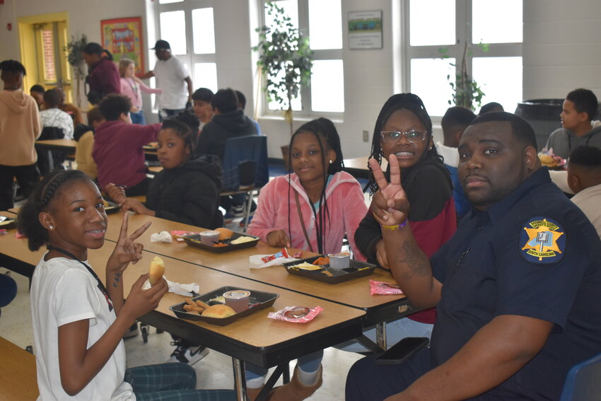 Shawn Howze spends time with Macedonia Elementary-Middle School students during a program called Lunch Buddies he implemented as a School Resource Officer with the Barnwell County Sheriff’s Office. 
