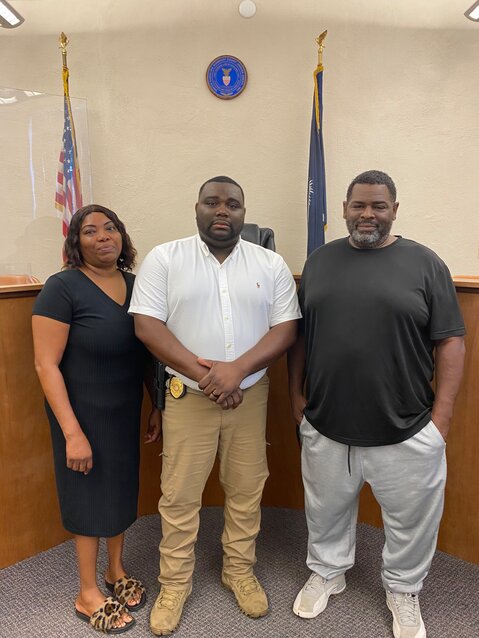 Shawn Howze stands with his parents, Shawn Sr. and Carla Howze, at his July 9 swearing in ceremony. 

