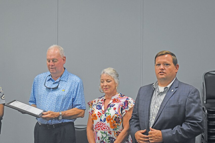 Williston Mayor Brett Williams (right) recognizes retiring magistrate judge Robert Cooper (left) during a special drop-in retirement party on June 10. Also pictured is Cooper's wife Helen.