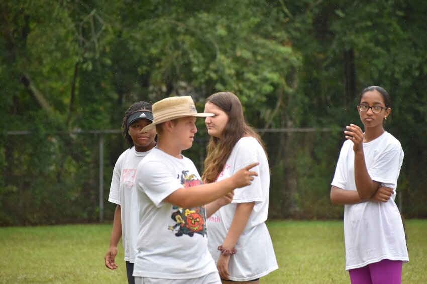 Nicholas Jones, co-drum major, helps his bandmates during a band camp practice.