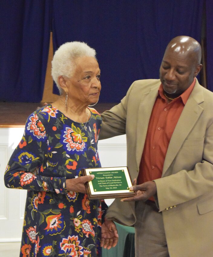 Mayor Ronnie Pernell hands Vivian Alston a plaque for her years of service to the Town of Blackville through the Blackville Downtown Development Association. 
