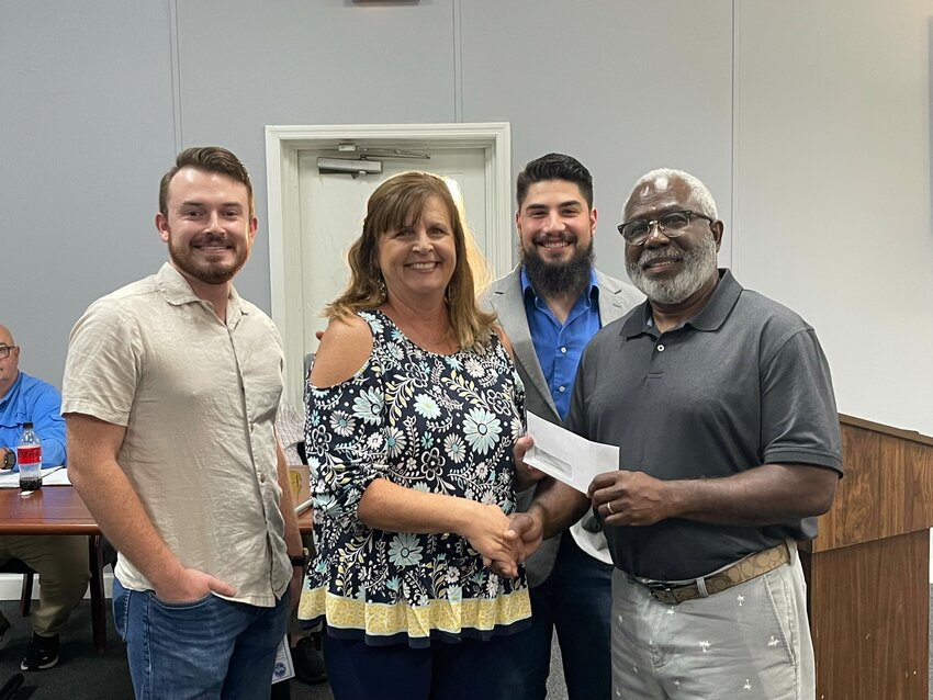 First Baptist Church of Williston Vacation Bible School (VBS) director Cathy Smith, FBC Pastor Joseph Sanders, and Next Gen Pastor Joshua Helms make a donation to the town’s recreation department after a successful summer of VBS. They are pictured smiling with recreation director Ronnie Tobin. 
