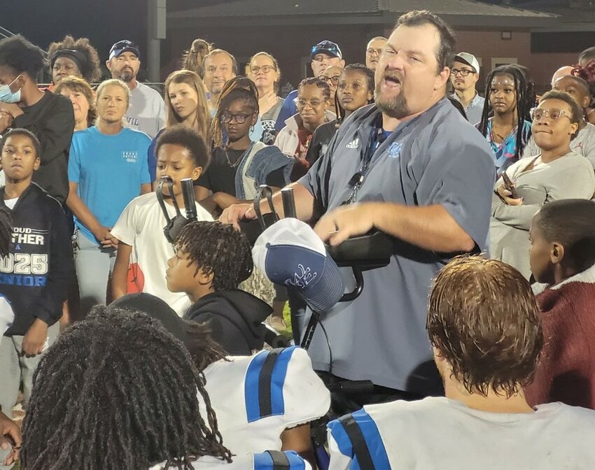 Blue Devil players and fans all gather around to hear Coach Lipsey talk to his team after their huge win over Pelion. 
