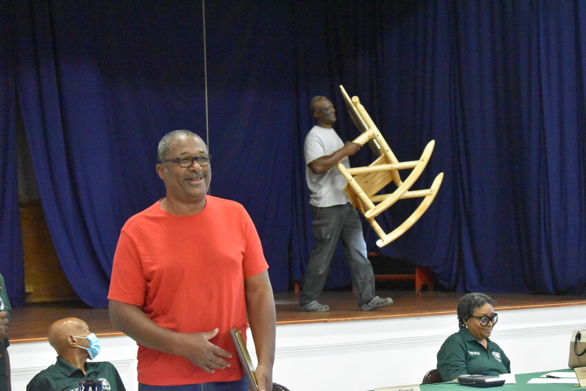 Clay Walker smiles as his brother and colleague, Earthel Walker, carries his retirement gift for him to try out. 