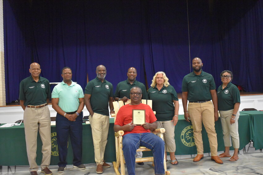 The Blackville Town Council honored Clay Walker’s (center) retirement with kind words and a gift of a plaque and a rocking chair. 
