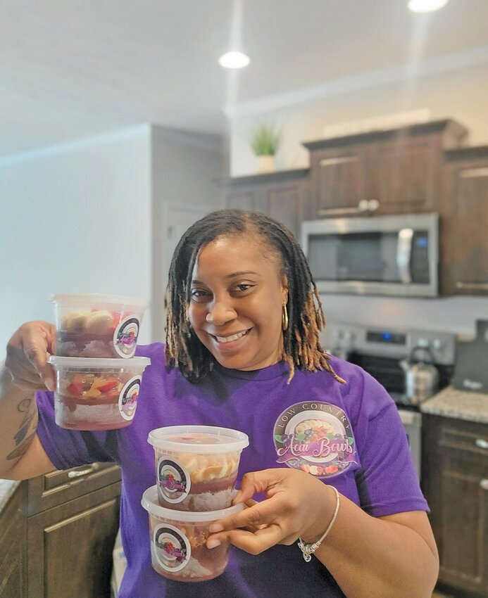 April Robinson, owner of Low Country Acai Bowls, smiles with two of her creations. 