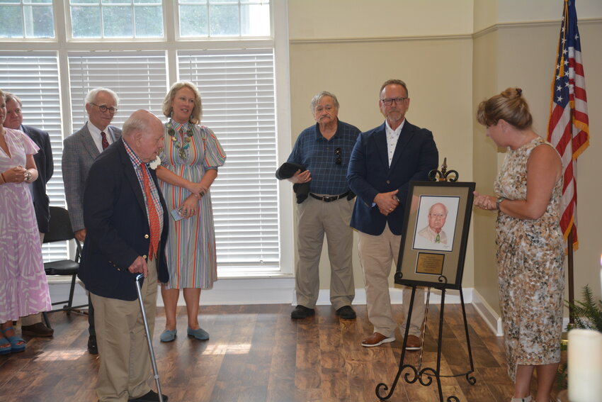 Tom Boulware sees his portrait created by Kell Anderson.