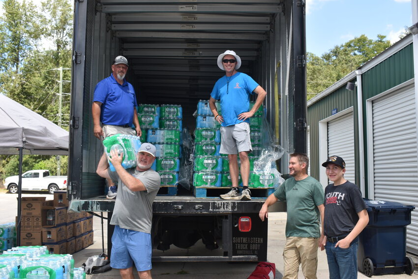 Volunteers and council members stepped up on Sunday, Sept. 1 and Monday Sept. 2 to hand out water to residents amidst the water outages. Pictured are councilman Eric Moody, Pastor Jaime Wooten, Joe Welch, Allen Searson, and Alex Searson unloading water off the truck. 