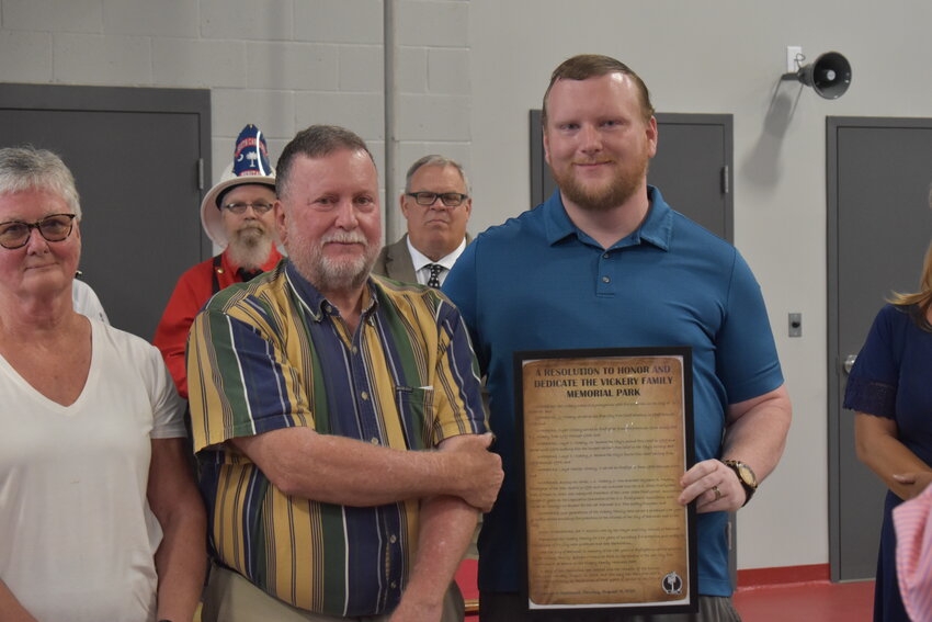 Jonathan Vickery (right) stands with his father, Charles Vickery, after accepting a plaque honoring their family's over 150 years of combined service to the fire department. 