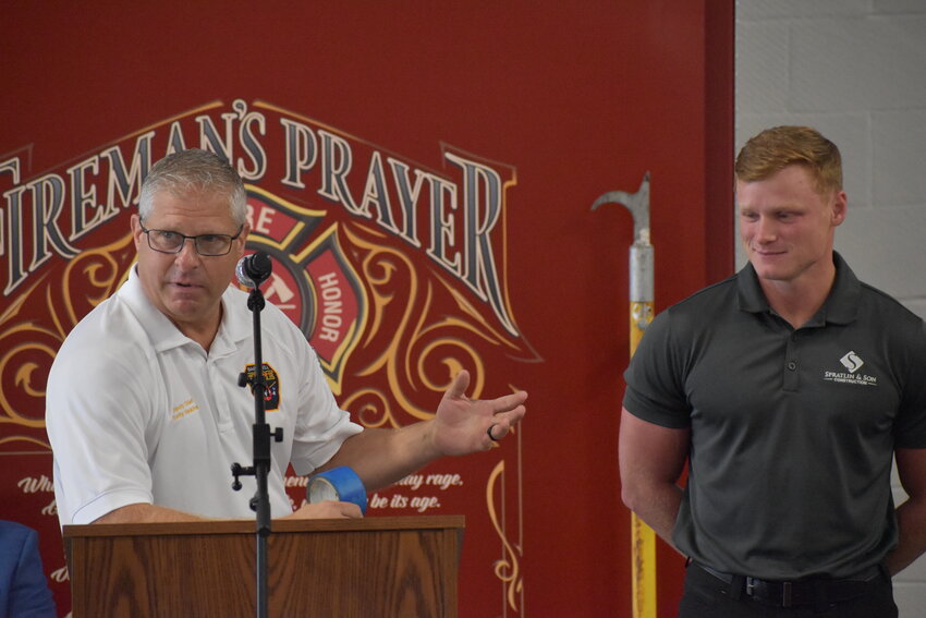 Assistant Fire Chief Scotty Hankins (left) jokes about the blue tape he and Olson would use to mark spots at the new station that needed to be finished or fixed during the construction process. 