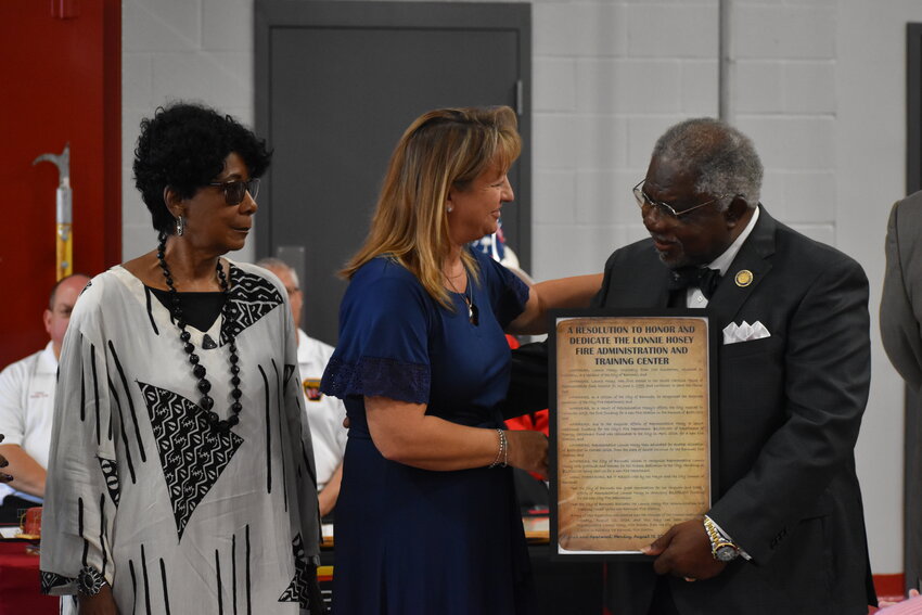 Representative Lonnie Hosey accepts a plaque and the naming of a space in the new station. He is pictured with City Administrator Lynn McEwen and his wife, Doris. 