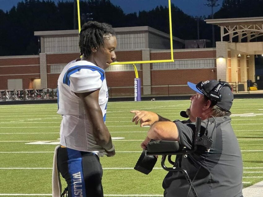 Devils QB Tony Dunbar talks with head coach Kenny Lipsey during Williston-Elko's 35-22 win over Eau Claire. 