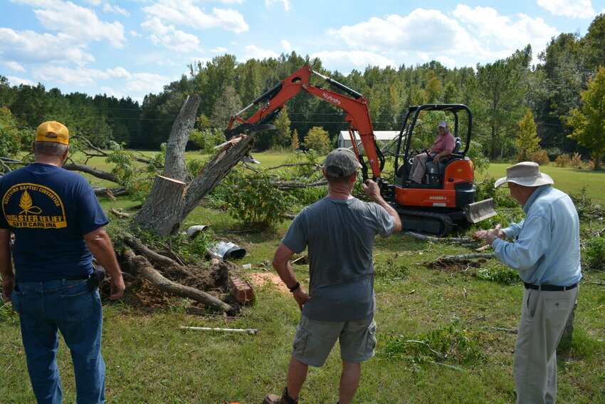 Wayne Jordan (right) was grateful for the help of S.C. Baptist Disaster Relief members who cleared downed trees.