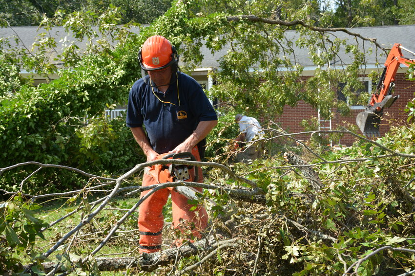 Dan Fogle with S.C. Baptist Disaster Relief cuts a tree at a home in Barnwell after the storm.