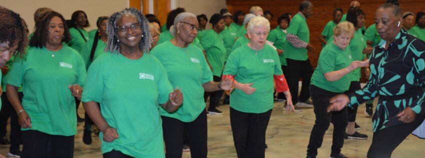 Earnestine Gloster (right) leads a dance at the December 11 reunion for the Better Choices, Better Health class.