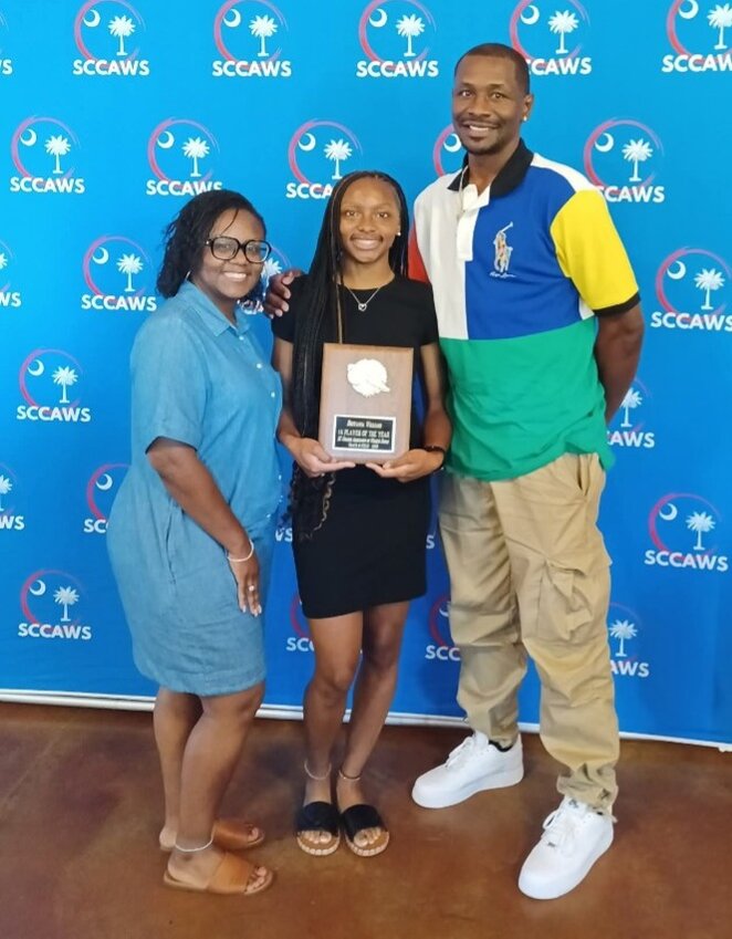 Blackville-Hilda's Breyanna Williams (pictured with her parents, Kenyatta and Maurice Williams) accepts her 2025 SCCAWS Track Player of the Year Award at the SCCAWS Player of the Year Banquet held at The Cotton Press in Little Mountain, S.C. on June 11.