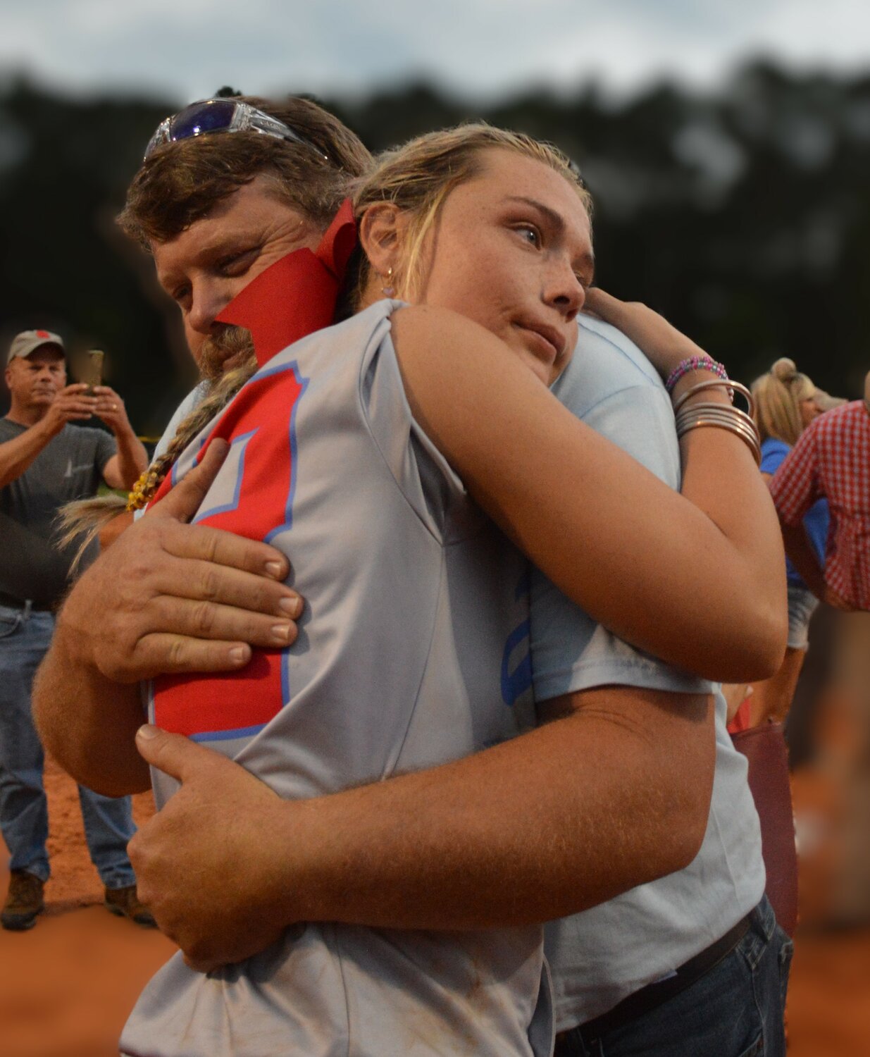Luther Googe hugs his daughter Gylian, #22 of the JDA
Raiders, after the team won the state championship.