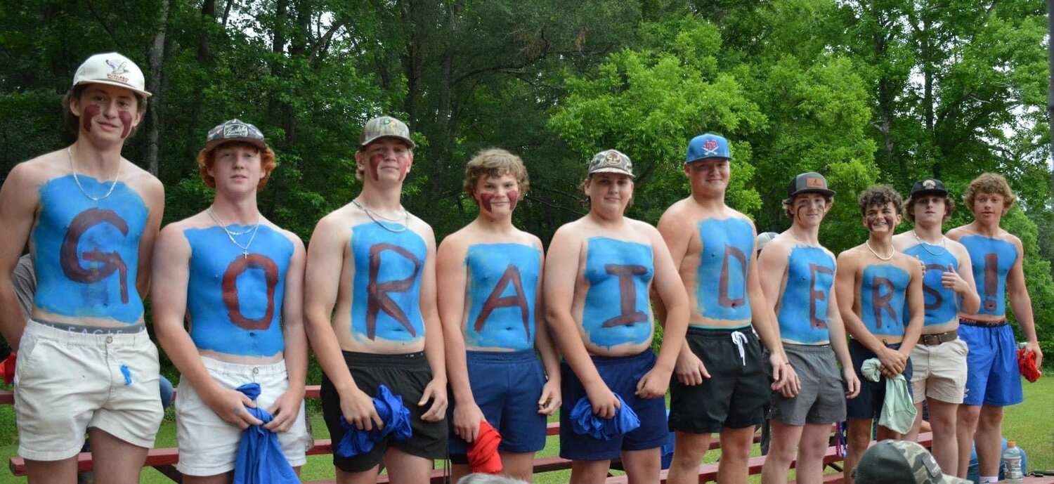 Male students from JDA show support for the softball team.