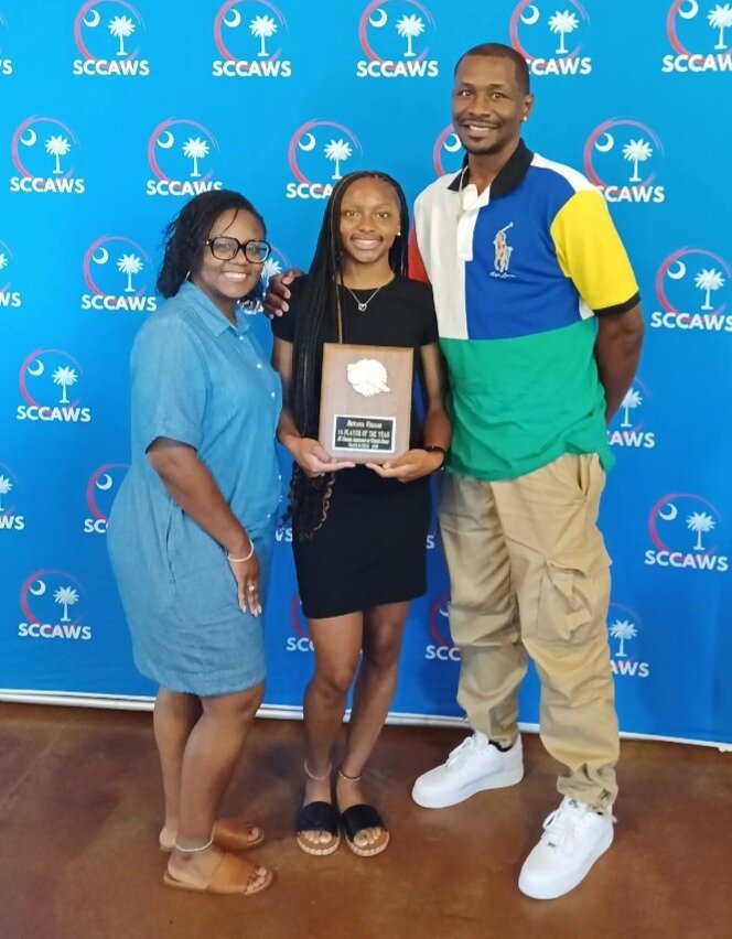 Blackville-Hilda's Breyanna Williams (pictured with her parents, Kenyatta and Maurice Williams) accepts her 2025 SCCAWS Track Player of the Year Award at the SCCAWS Player of the Year Banquet held at The Cotton Press in Little Mountain, S.C. on June 11.