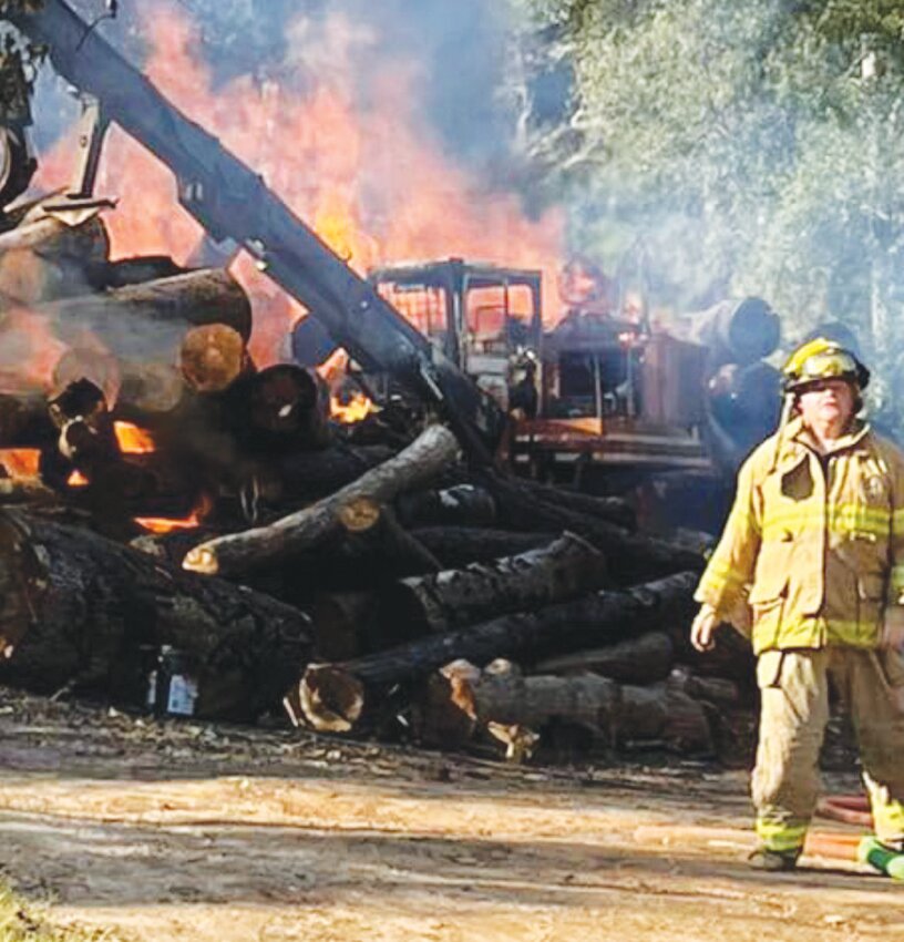 Trinity VFD firefighters assisted the Onalaska Fire Department with extinguishing a blaze that broke out on a large pile of timber.  COURTESY PHOTO