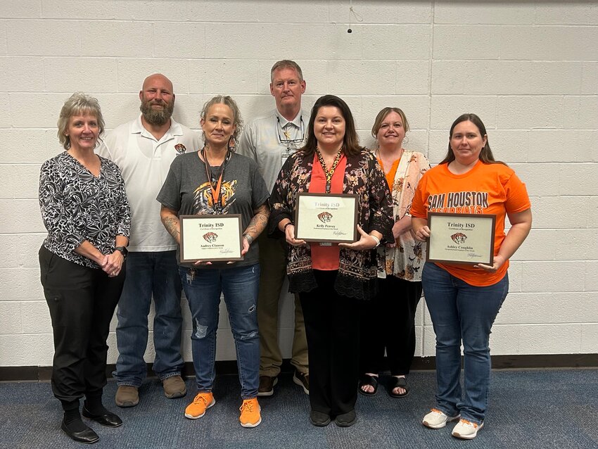 The Trinity ISD Board of Trustees honored the employees of the month at the Sept. 23 board meeting. Pictured are Support Staff winner Audrey Clauson, Professional Staff winner Kelly Peavey, Paraprofessional winner Ashley Coughlin, and Elizabeth King, Board Member; Allen Ramsey, Transportation Director; Jerry Herd, Middle School Principal; and Brittaney Cassidy, High School Principal.