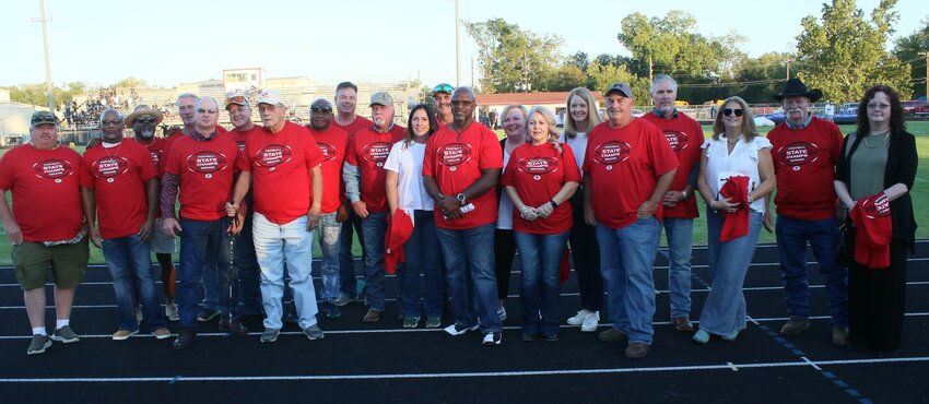 Members of the 1984 and 1985 state champion football teams were recognized at the Friday Groveton homecoming game and were gifted with shirts from Head Football Coach Michael Waldie.