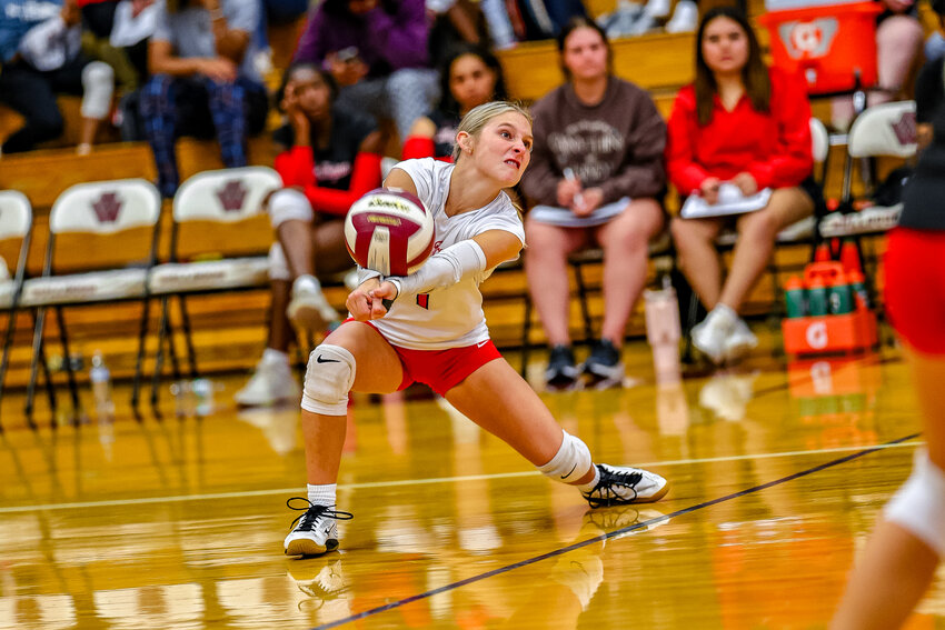 Kinsey Reynolds digs a ball out for a set during the first district game against the Lady Bulldogs on Friday night.