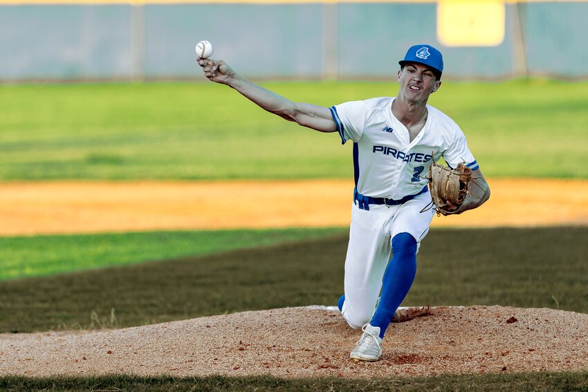 Marshall Reeves delivers a strike during the first district game of the season against Tarkington.  PHOTOS BY CHARLES BALLARD