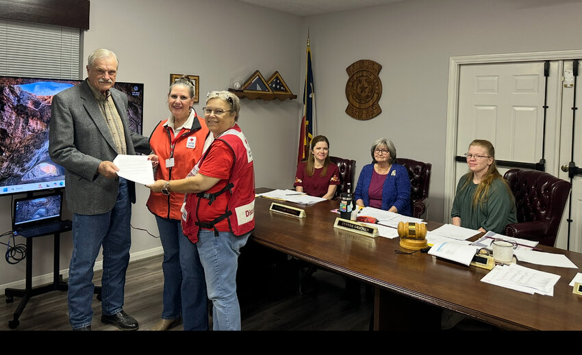 Mayor John Benestante, along with the Coldspring City Council, hands Red Cross representatives a proclamation naming March as Red Cross Month.