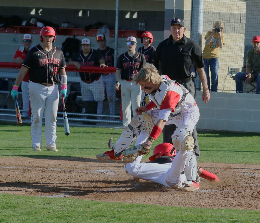 Groveton’s Jake Plotts beats the throw at home, sliding under the tag by Centerville’s Kolt Larsen.