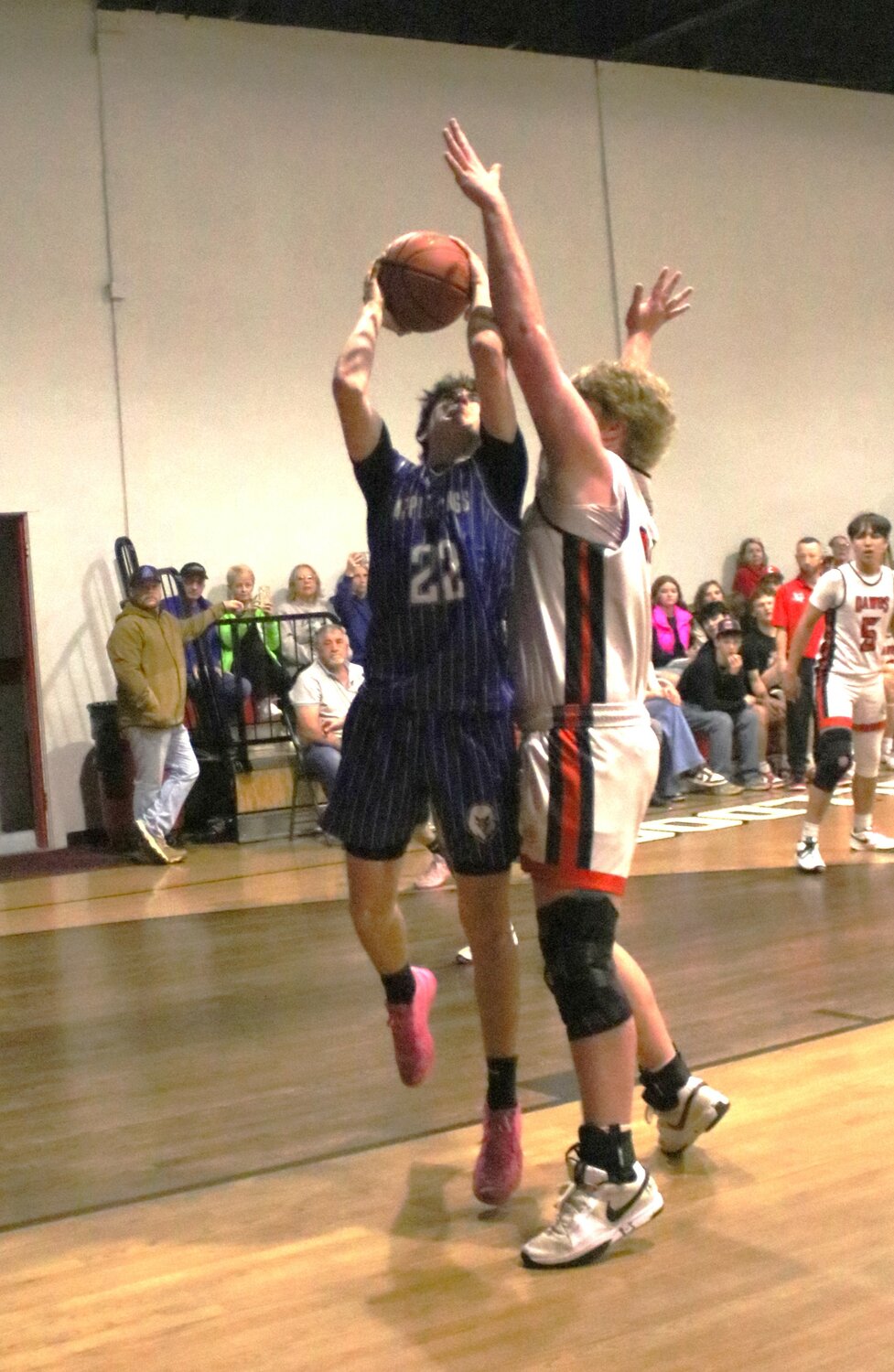 Apple Springs’ Cooper Campbell (No. 22) shoots over the defense by Centerville’s Jake Slaten.