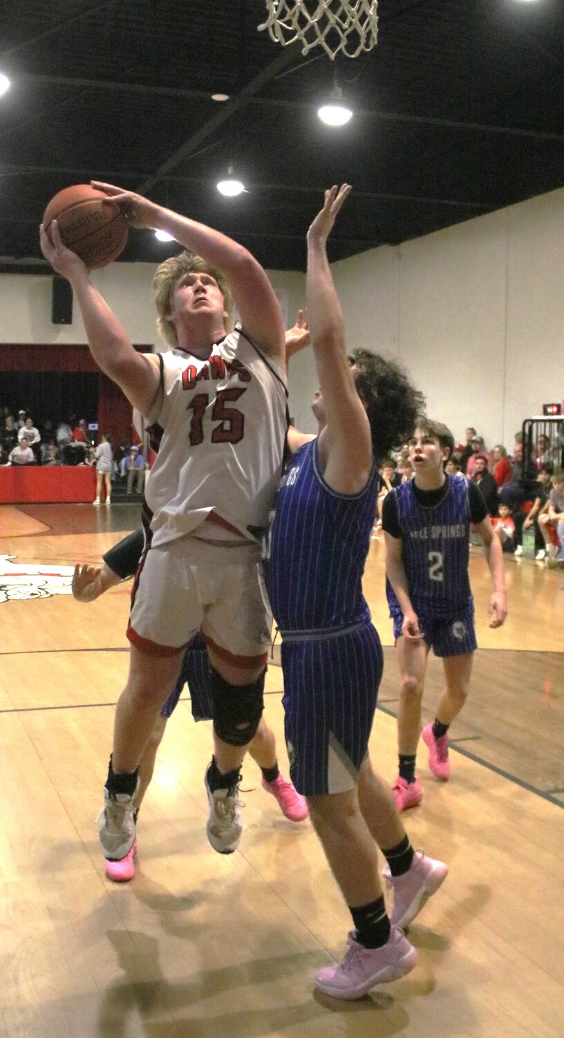 Centerville powerhouse Jake Slaten (No. 15) muscles in for the shot.