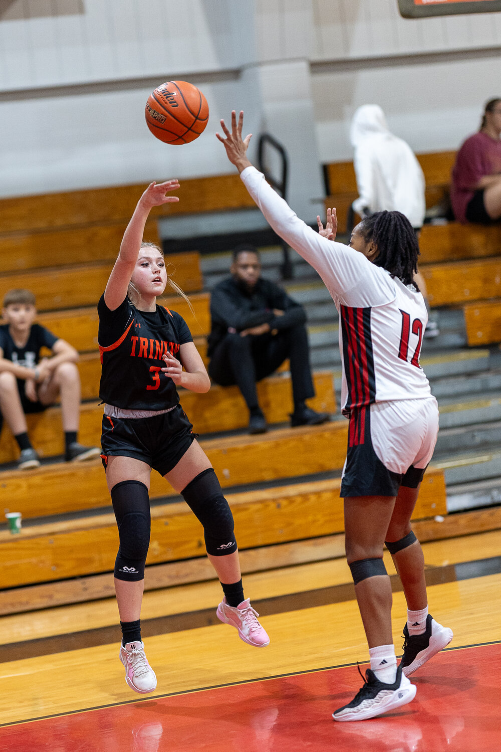 Emma Sustaita shoots over a Lady Trojan.