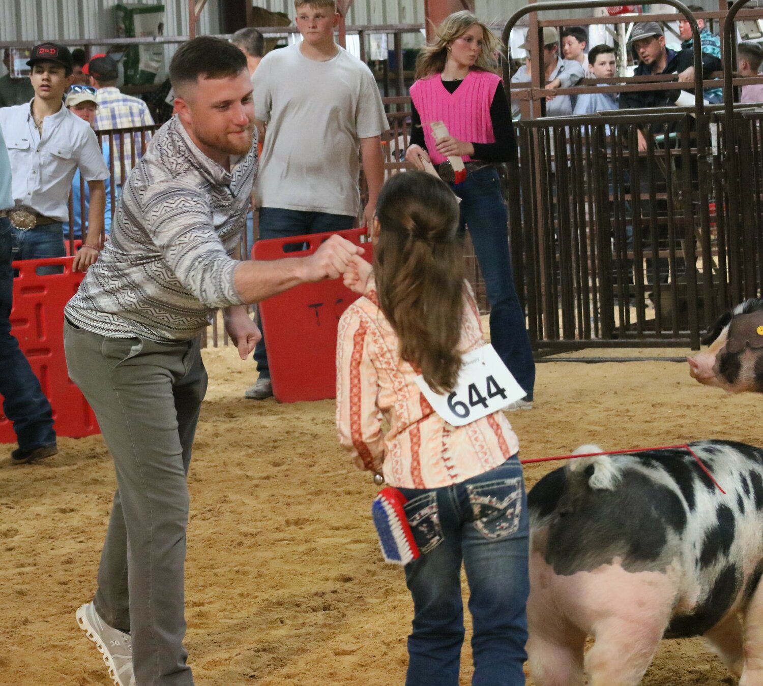 The judge of the Swine Show congratulates a breed champion during Friday’s event.
