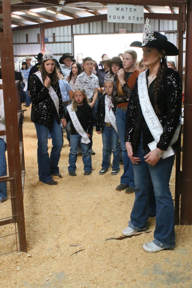 The Trinity County Fair and Youth Livestock Show queens and princesses, along with other fair participants, await their awards.