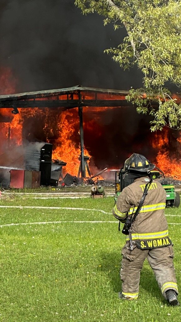Firefighters attack a blaze that broke out in a garage shop on Highway 94.