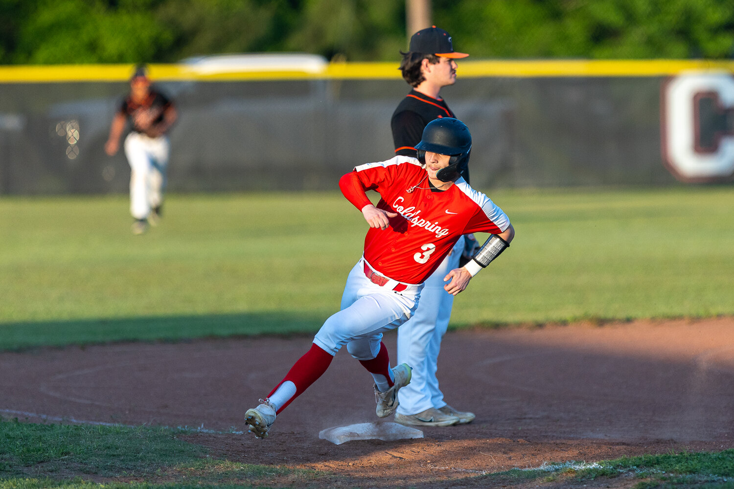 Brennan Headley rounds third and is headed for home for another score for the Coldspring Trojans.