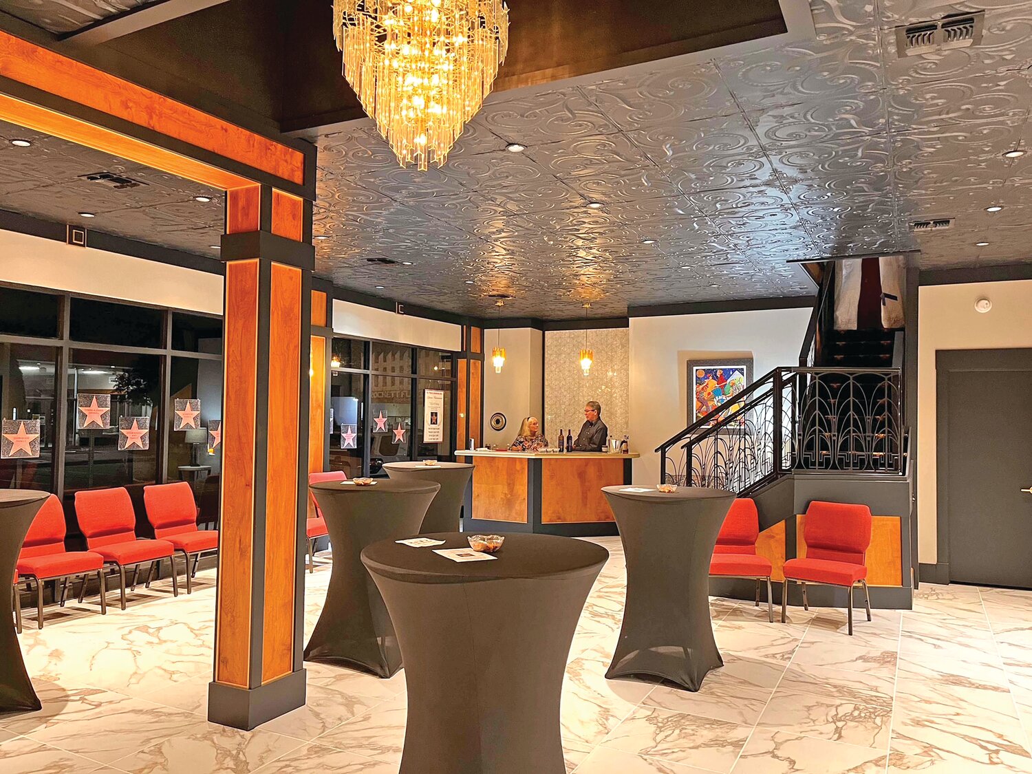 Newly renovated lobby featuring handcrafted handrails and restored antique chandelier. Photo courtesy of Jacque Fleming.