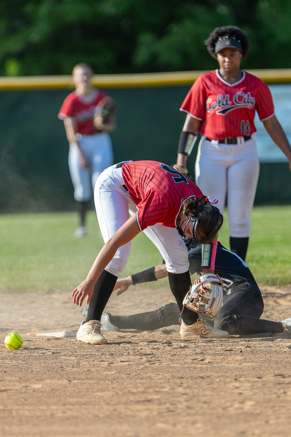 Jasper Williams hunts for the softball during an attempted steal.