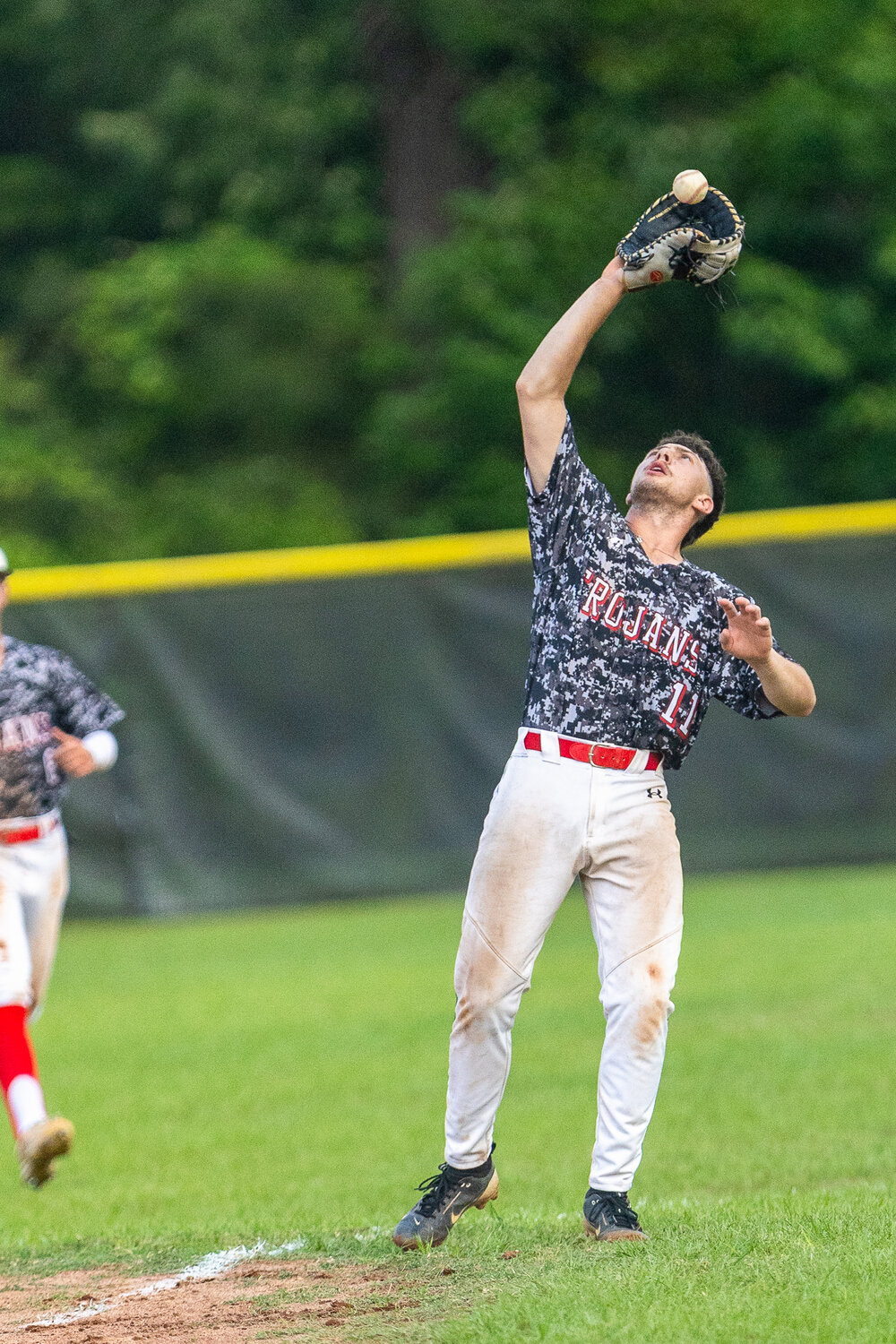 First Baseman Wade Currie grabs a high pop-up during a warmup game against the Lovelady Lions.