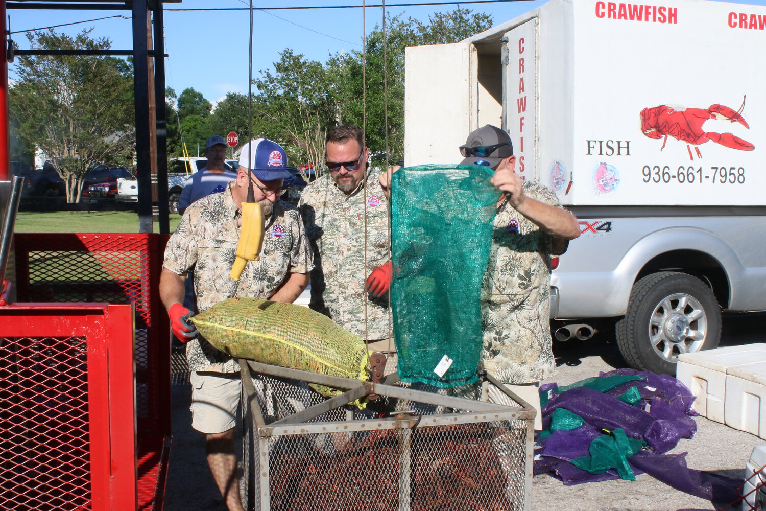 Eric Van Dorn (center) of Big E-Z Crawfish and his crew load sacks of crawfish into a hopper in preparation for a boil.