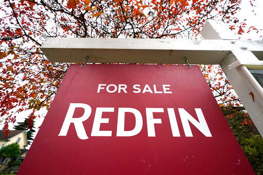 FILE - A Redfin &quot;for sale&quot; sign stands in front of a house on Oct. 28, 2020, in Seattle. The National Fair Housing Alliance on Friday, April 29, 2022, announced a settlement agreement to resolve a lawsuit against Redfin that will expand housing opportunities for consumers in communities of color in major cities. Under the agreement, Seattle-based Redfin will change its minimum housing price policy, alter other practices, and pay $4 million. (AP Photo/Elaine Thompson, File)