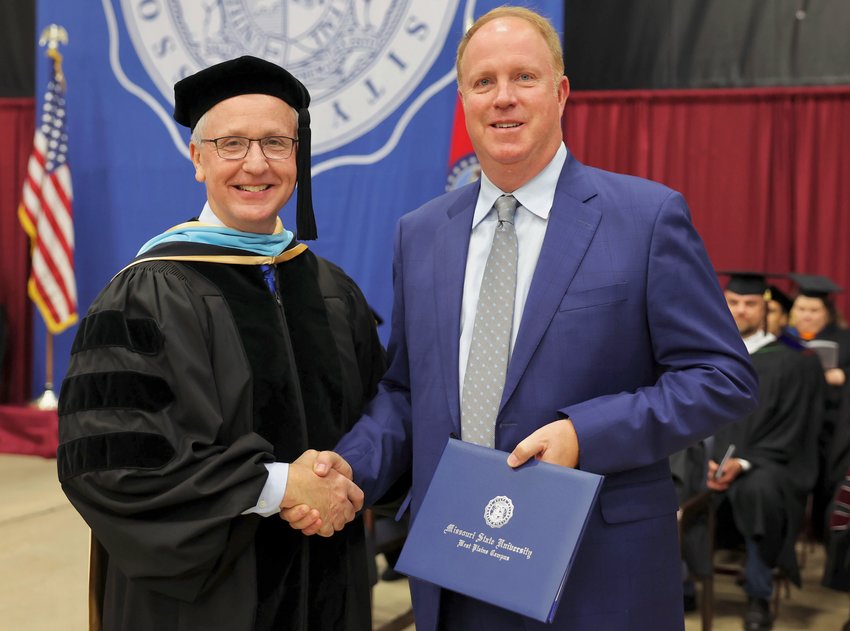 Area businessman Mike Ennis received an honorary Associate of Applied Science degree Saturday during Missouri State University-West Plains&rsquo; annual commencement ceremony at the West Plains Civic Center. Ennis, right, receives the degree from Chancellor Dennis Lancaster.