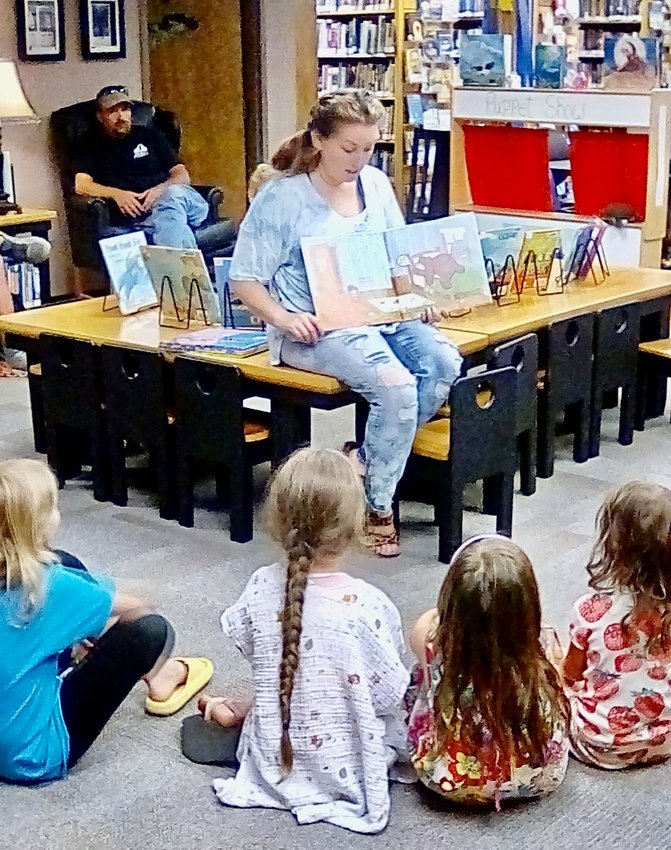 Tiffany Davy reads to children at the Summersville Branch of the Texas County Public Library.