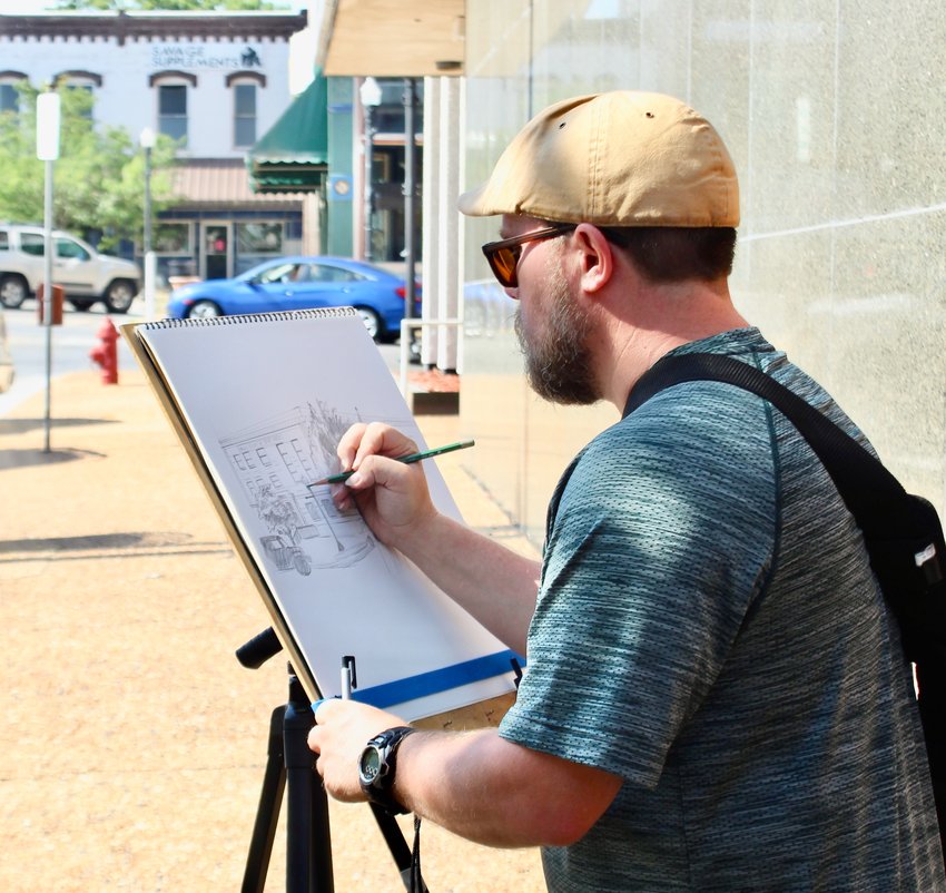 Nate Billings, of Pierce City, sketches the Howell County Courthouse on Friday morning. The building is the 13th courthouse he has drawn to date as part of an endeavor to sketch all 144 county courthouses in Missouri. After sketching the building in West Plains, Billings traveled to Alton to sketch the Oregon County Courthouse.