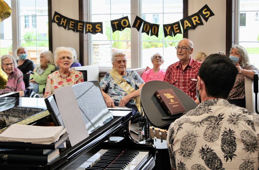 Allena Redburn Vonallmen, center, turned 100 years old Thursday and was thrown a birthday party, complete with a musical singalong, by staff with Three Rivers Hospice and Cedarhurst. Left of Allena is her daughter-in-law, Carolyn Vonallmen, and right of Allena is her son, Charles.