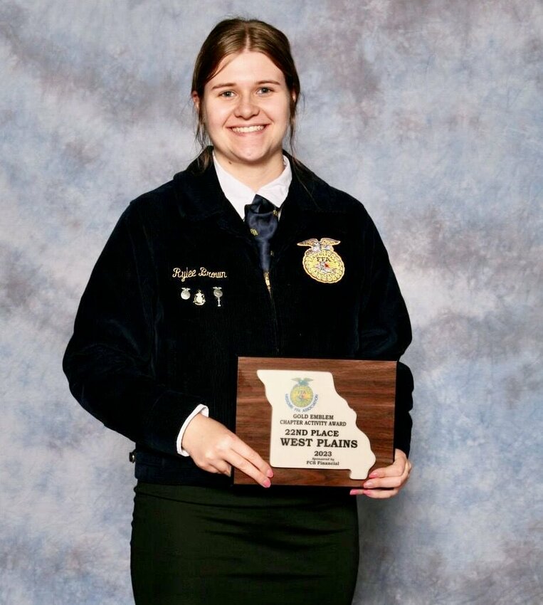 Rylee Brown, president of the West Plains FFA chapter, holds a plaque with a gold emblem designating the local group a top chapter in the Missouri FFA Association. Brown was also individually recognized as Area 13 Star in Agribusiness for her horticulture enterprise.